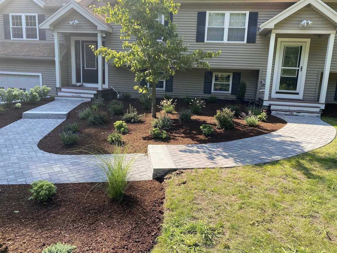 Residential front walkway with new plantings, mulch beds and stone steps